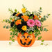 Grin & Bloom Pumpkin Bouquet, fresh Halloween flowers with orange roses, black carnations and pink gerberas in a jack-o’-lantern pumpkin container