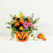 Halloween pumpkin flower arrangement with yellow tulips, black carnations and trailing ivy, same day flower delivery in Singapore