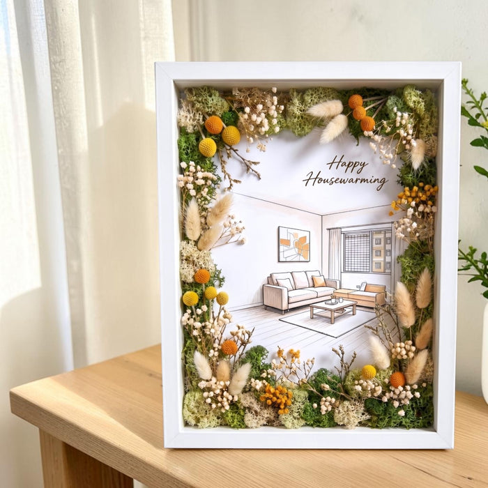 Preserved flower photo frame displayed on a living room shelf alongside a candle and books, home decor gift idea Singapore.