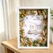 Preserved flower photo frame displayed on a living room shelf alongside a candle and books, home decor gift idea Singapore.