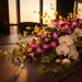 Purple dendrobium and white orchid table arrangement with sunset backdrop | Well Live Florist Singapore