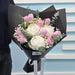 Hand-crafted fresh flower bouquet with pink tulips, white peonies, and delicate greenery for special occasions