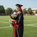Graduate holding Royal Achievement tulip graduation bouquet outdoors