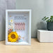 Sunshine Fortune Frame with sunflower, rose and hydrangea displayed on wooden tabletop