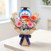 Unboxing the Turn the Tassel fresh flower bouquet—gerberas, daisies, and statice arranged with eucalyptus for graduation delivery in Singapore.