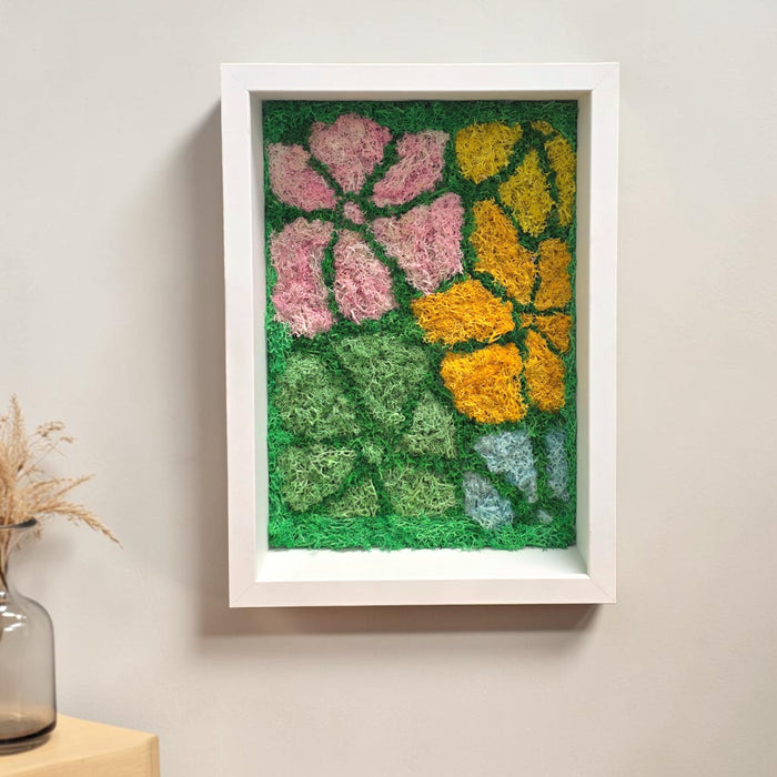 Whimsical Bloom Moss Frame displayed on a wall, demonstrating how the 23cm wide by 32cm tall piece complements modern home décor in a living room or bedroom setting.