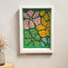 Whimsical Bloom Moss Frame displayed on a wall, demonstrating how the 23cm wide by 32cm tall piece complements modern home décor in a living room or bedroom setting.