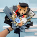 Graduation bear with preserved blue rose bouquet, black wrap
