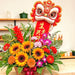 Close-up of lion dance flower basket with 生意兴隆 banner, sunflowers and orchids