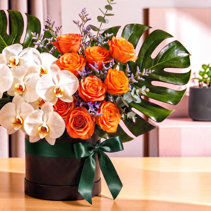 Close-up of orange roses, purple limonium and eucalyptus in Tropic Sunrise flower box, same day delivery Singapore