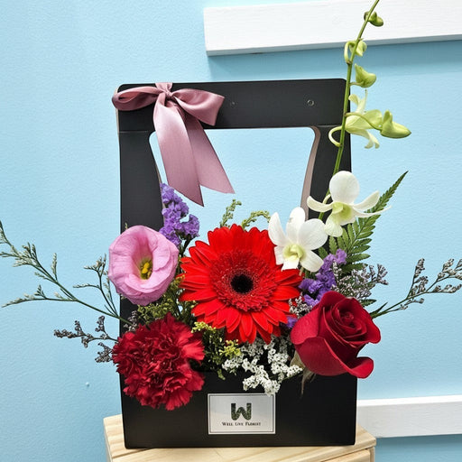 Well Live Florist Bold Delight flower box with red gerberas, roses, carnations, pink eustoma, and white orchids.