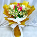 Hand bouquet, fresh tulips, daisy and foliage