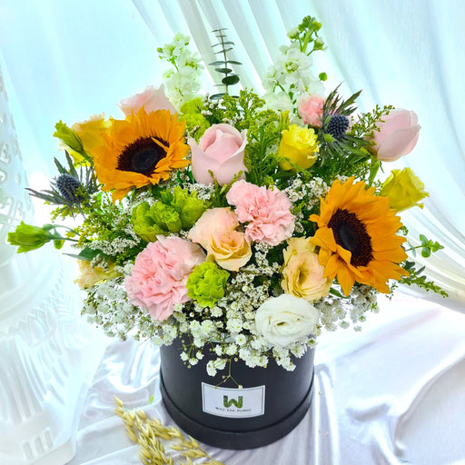 Captivating flower box of colorful fresh roses, sunflower, carnation , pom pom, eustoma, matthiola, baby breath and foliage.