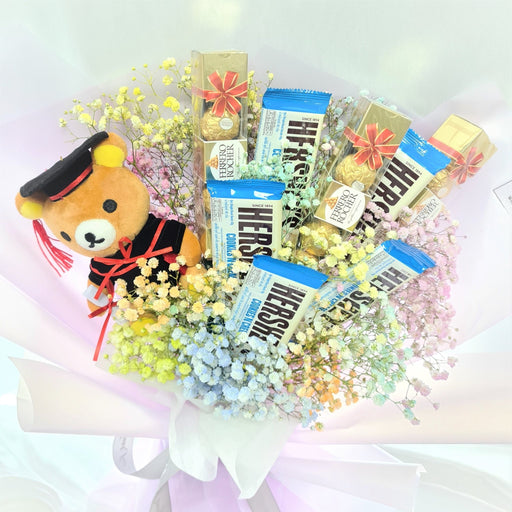 Unique hand bouquet of stunning baby's breath, chocolate and graduation bear.