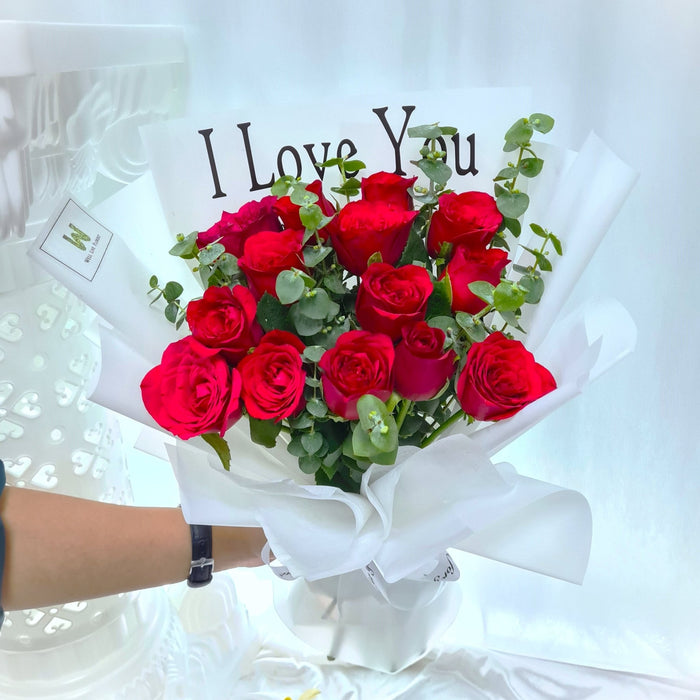 hand bouquet of red color roses and foliage.