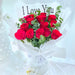 exquisite hand bouquet of red color roses and foliage.
