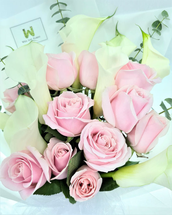 Ravishing hand bouquet of gorgeous calla lilies and pink roses.