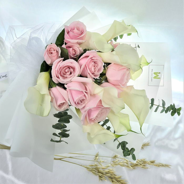 Ravishing hand bouquet of gorgeous calla lilies and pink roses.