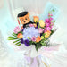 Enticing hand bouquet of magnificent roses, eustoma, hydrangea, mathiola and a graduation toy bear