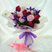 Charming hand bouquet of gorgeous fresh roses and iris