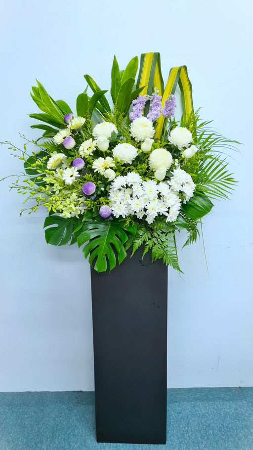 This stunning flower stand is a beautiful floral tribute that thoughtfully expresses your condolences.