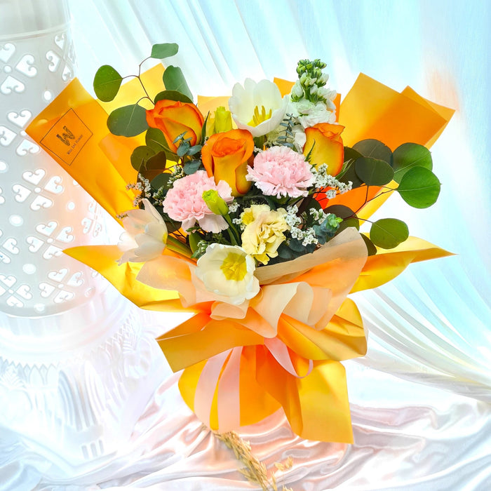 Mesmerising hand bouquet of elegant fresh orange roses, matthiola, eustomas, tulip, carnation and foliage