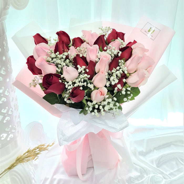 Irresistible hand bouquet of 34 elegant fresh stalk roses, baby's breath, and foliage.