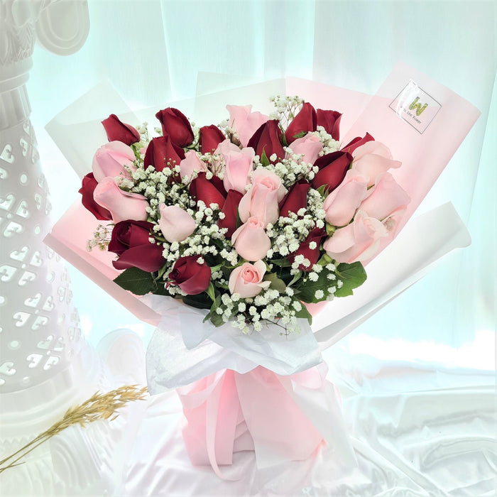 Irresistible hand bouquet of 34 elegant fresh stalk roses, baby's breath, and foliage.