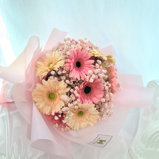 Ravishing hand bouquet of stunning gerbera and baby's breath.