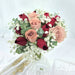 Exquisite hand bouquet of enticing red / cappuccino roses and baby's breath.