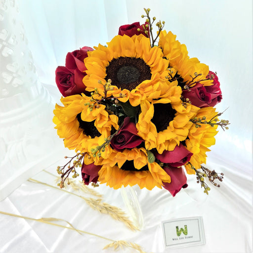 hand bouquet of sunflower and red roses.