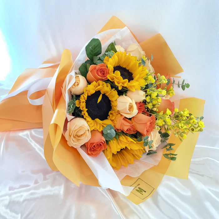resh-cut sunflowers, wax flower, and roses.