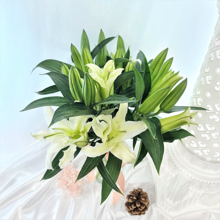 Captivating table arrangements of enthralling white lilies.