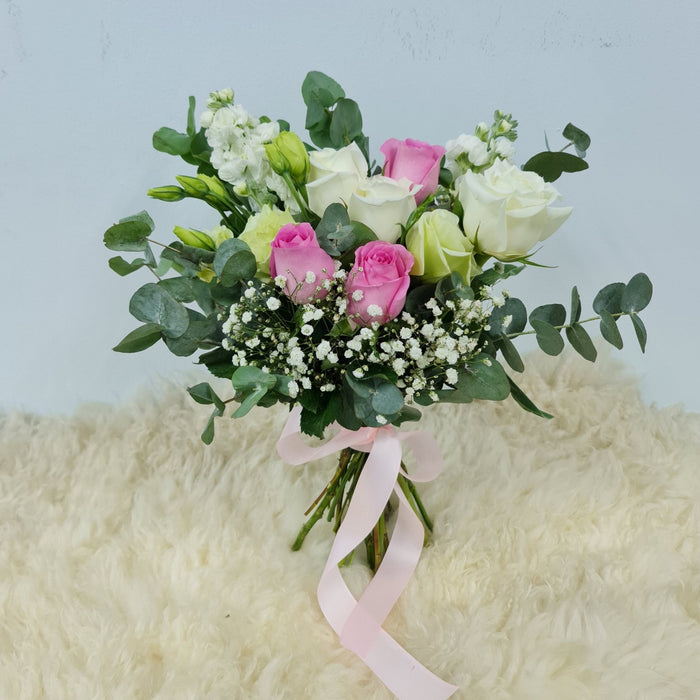Ravishing extremely attractive bridal bouquet of elegant pink and white roses, eustoma, Fillers flowers and foliage.
