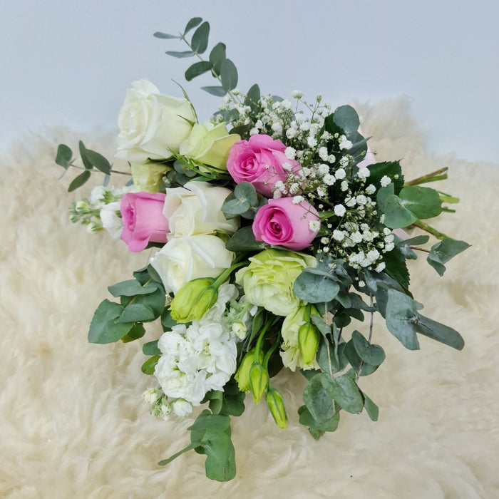 Ravishing extremely attractive bridal bouquet of elegant pink and white roses, eustoma, Fillers flowers and foliage.