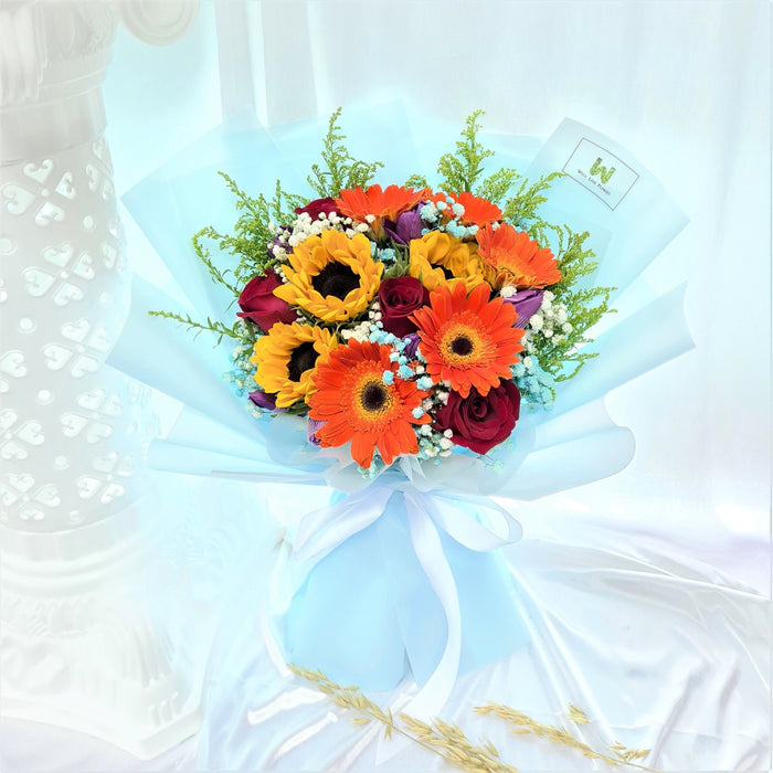 Bouquet includes sunflower, roses, gerbera, tulips, baby's breath and foliage.