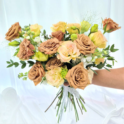 Exquisite hand bouquet of ravishing cappuccino roses, eustoma, mathiola and foliage