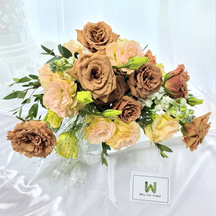 Exquisite hand bouquet of ravishing cappuccino roses, eustoma, mathiola and foliage