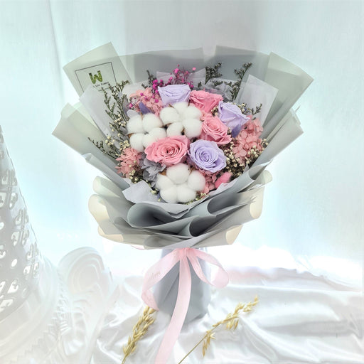 Luxurious hand bouquet of enthralling preserved roses, hydrangeas, cotton and dried foliage.