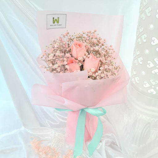 Gorgeous hand bouquet of 3 beautiful roses and baby's breath.