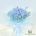 Fresh cut blue hydrangea, baby breath and foliage hand bouquet