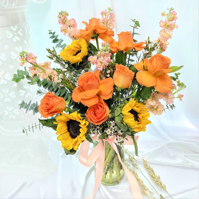 orange roses, wax flower, matthiola, sunflowers and foilage