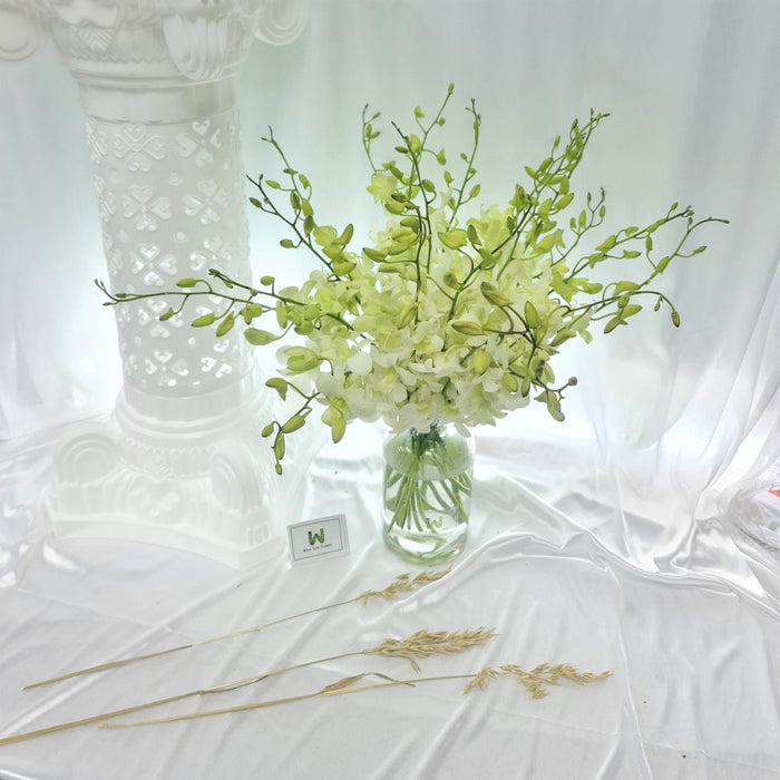 Mesmerising white orchids table arrangement to impress any guest.