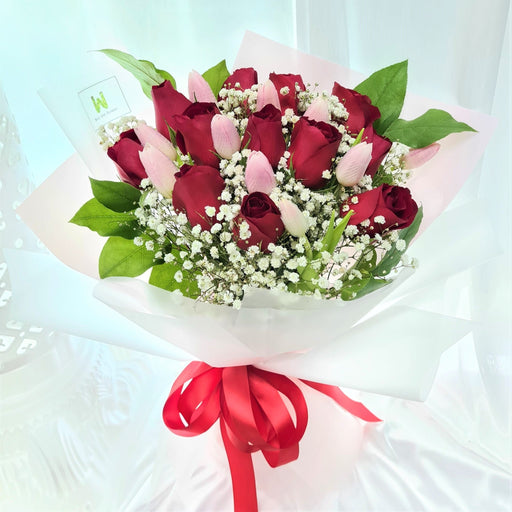 Irresistible hand bouquet of 12 elegant fresh stalk roses, tulips, baby's breath, and foliage